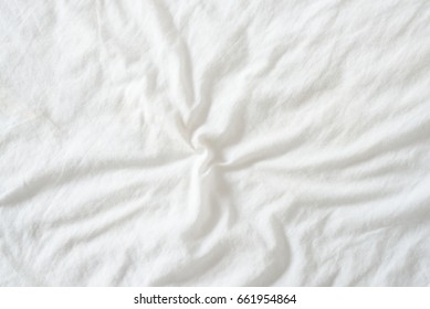 Random Abstract Pattern Of A White Crumpled Bed Sheet In A Hotel Room. The Manufacturing Of Bedsheet Uses Cotton, Cotton Blends, Polyester And Others Fibers Such As Linen, Silk Modal And Bamboo Rayon.