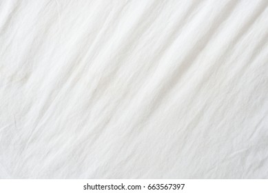 Random Abstract Pattern Of A White Crumpled Bed Sheet.