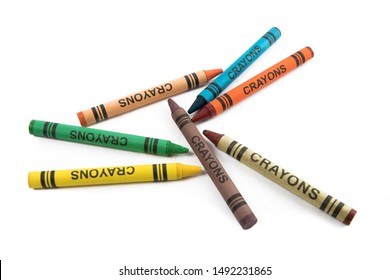 A Random Assortment  Of A Child's Colorful Crayons With A Generic Label Isolated On White