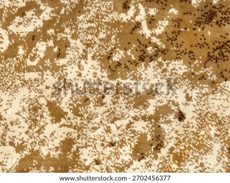 Random design with abstract pattern hand tufted carpet texture, in yellow, gold, and brown color. Random wavy washed pattern carpet rug seamless background texture