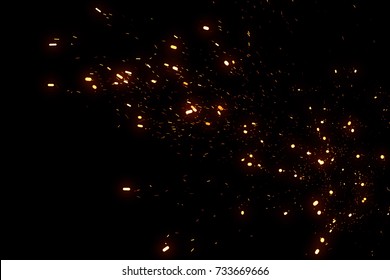 Random flying fire sparks particles isolated on the black background for overlay design. - Shutterstock ID 733669666