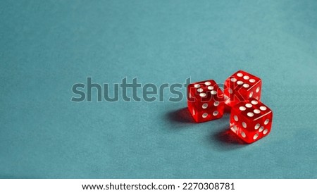 Random number generator. Three red dice with numerical values lie in a chaotic order.