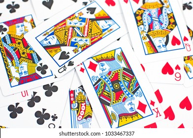 Random playing cards scattered on a surface.
