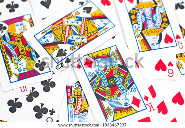 Random playing\
cards scattered on a\
surface.