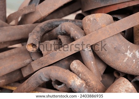 Random rusty metal cutoffs piled up. Thick metal piping