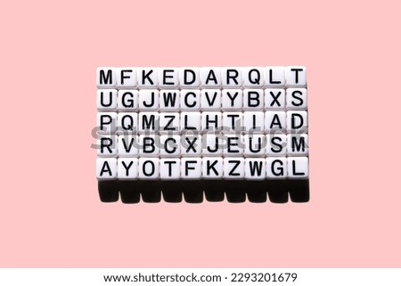 Random set of letters of the English alphabet. Isolated on pink background