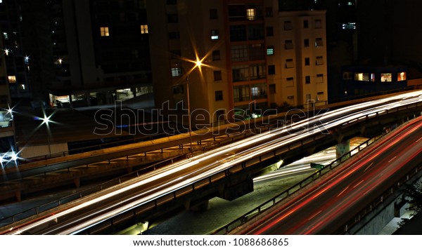 Range of light on the overpass.\
Effect on long\
exposure of cars in viaduct. Red lights and white lights passing by\
and leaving their mark.