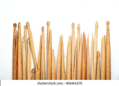 Range of mixed old broken used wooden drumsticks on white background