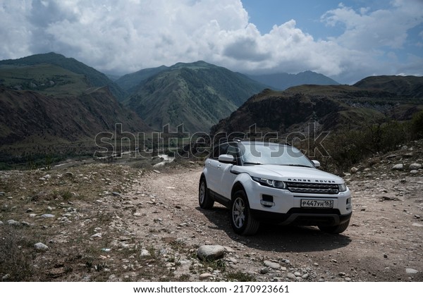 Range\
Rover Evoque car on the background of the mountains of the North\
Caucasus in Russia. Cloudy day on June 7,\
2022