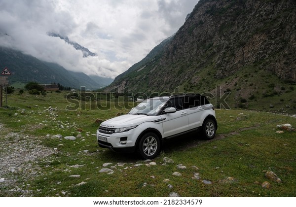 Range\
Rover Evoque car on the background of the mountains of the North\
Caucasus in Russia. Cloudy day on June 9,\
2022