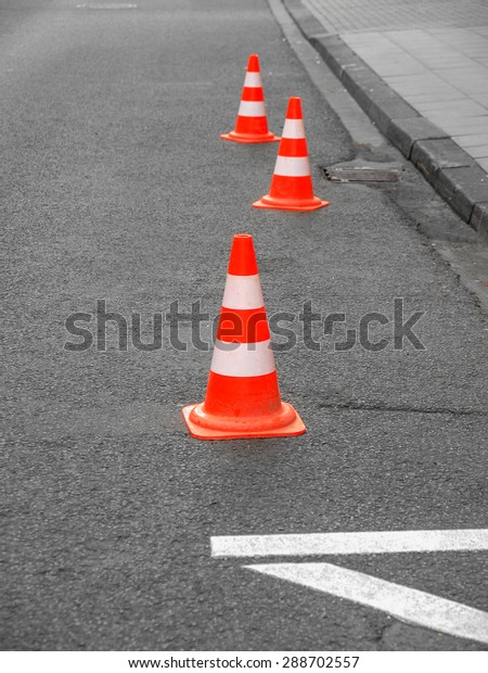 Range of traffic cones for road works -\
Selective colour over desaturated\
background