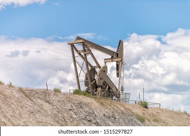 Rangely, USA - July 22, 2019: Colorado City With Closeup Of Hill Construction Sign And Pump Jack Drilling For Oil Isolated Against Sky