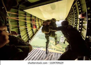 Rangers Parachuted From Military Airplanes, Soldiers Parachuted From The Plane, Isolated Airborne Soldier, Practice Parachuting, Paratroopers Jumping From An Airplane.