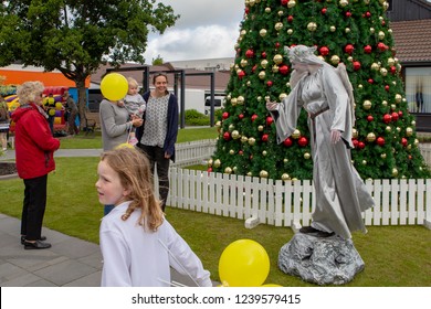 Rangiora, New Zealand - November 23 2018: A Street Performer Entertains People In Front Of A Decorated Christmas Tree