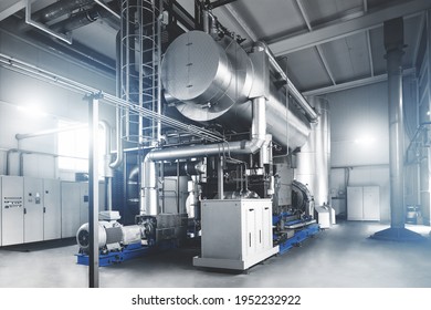 Rankine organic cycle turbine (ORC-turbine) installed in modern industrial boiler room with control cabinets, equiped for heating process. Blue toning