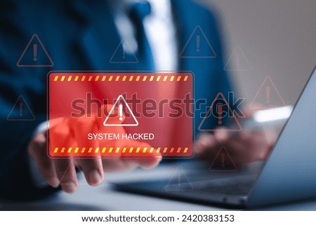 Ransomware malware attack and data breach. Businessman use laptop with virtual screen of system hacked warning sign. spam virus with warning caution for notification on internet security protect.