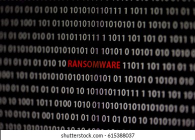 Ransomware text on the middle of the screen surrounded by 1 and 0. Binary code with one and zero numbers. Text is red. Cyber threat concept image.