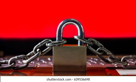 Ransomware,Malware,Encrypt and Hacking Conceptual with Padlock.The Old padlock and Chains On Laptop with Red Screen.Ransomware stops and block access to a Computer and Data