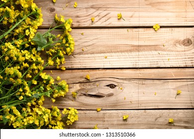 Rape flower on wooden table