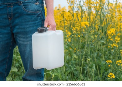 Rapeseed Crop Protection Concept, Female Farmer Agronomist Holding Jerry Can Bottle Container With Pesticide, Selective Focus