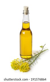 Rapeseed Oil In A Bottle And Flowers Isolated On White Background