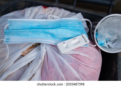 Rapid Covid Test, Face Mask And Coffee Cup In Waste Bin. How To Clean Nature.