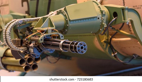 A Rapid Fire “Gatling Gun” Attached To The Side Of A Military Helicopter