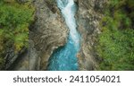 Rapid flow of a mountain river in a deep stone gorge, Austria. Lammerklamm hiking route. Spring clear water in ravine. Top down view.