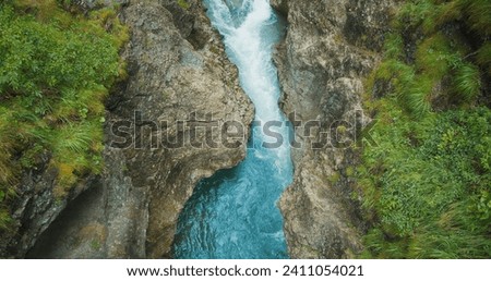 Rapid flow of a mountain river in a deep stone gorge, Austria. Lammerklamm hiking route. Spring clear water in ravine. Top down view.