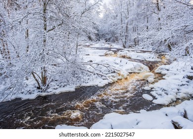 Rapid Water In A River In A Wintry Forest Landscape