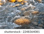 Rapids in fast flowing river close up.