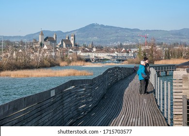 RAPPERSWIL, SWITZERLAND - MARCH 3, 2020: The longest wooden bridge of Switzerland, built in 2001, a walkway across lake Zurich from Hurden to Rapperswil.
