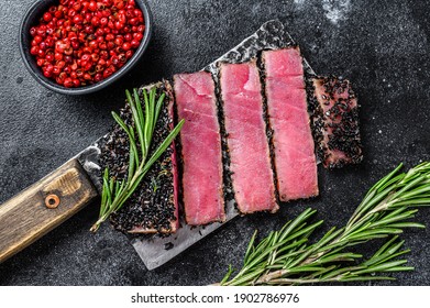 Rare Ahi Tuna Steak Slices On A Meat Cleaver. Black Background. Top View.