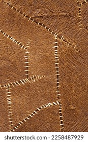 Rare brown cloth sewn with white string. fabric background texture