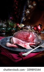 Rare Cooked Sliced Roast Beef Joint Against A Rustic Christmas Background With Generous Accommodation For Copy Space. A Concept Image For Your Thanksgiving Menu Cover Designs.