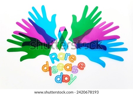 Rare Disease Day Background. Colorful hands and ribbon on white background