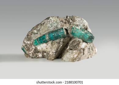 A Rare Gem Nugget. Beryl (emerald) Is A Prismatic Crystal In Phlogopite Mica. Expensive Green Crystal.