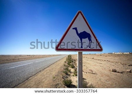 Rare highway warning sign, Western Sahara desert in Morocco.
