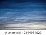 Rare noctilucent clouds glowing on the sky at night.