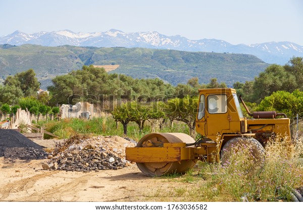                \
               A rare road roller, road construction machine.\
Making road on mountain\
village.