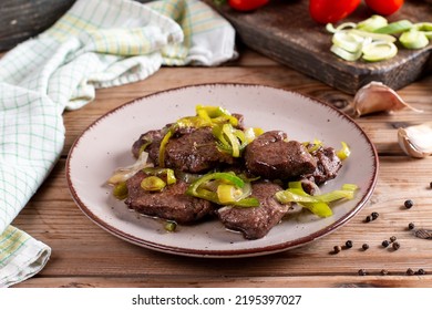 Rare Roasted Thick Juicy Beef Fillet Medallion Topped With Leek On Rustic Wooden Table