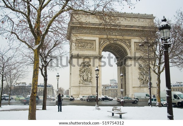 Rare\
snowy day in Paris. Arc de Triomphe and lots of\
snow