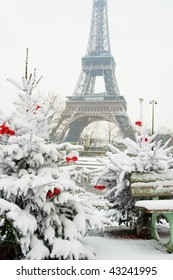 Rare Snowy Day In Paris. The Eiffel Tower And Decorated Christmas Tree