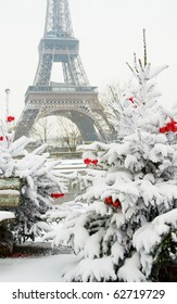 Rare Snowy Day In Paris. The Eiffel Tower And Decorated Christmas Tree