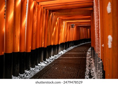 A Rare Winter snow at Torii Gate Tunnel at Fushimi Inari Shrine in Kyoto Japan. Orange and black beams with traditional Japanese Lanterns - Powered by Shutterstock