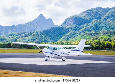 Rarotonga, Cook Islands Small Airport Field And A Plane Against Beautiful Mountains