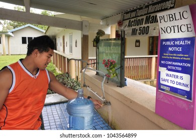 RAROTONGA - DEC 20 2017:Pacific Island Man Fill Up Fresh Water From A Water Station.The Water On Rarotonga Island Is Filtered But Not Treated And Can Become Slightly Muddy After Periods Of Heavy Rain.