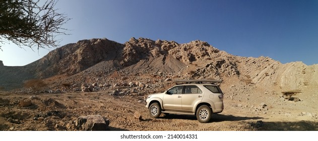 Ras Al Khaimah, United Arab Emirates - March 28, 2022: 4x4 Vehicle (4WD, SUV) Off-road In Rocky Desert Mountain Terrain In Wadi Naqab (ravine, Dry Riverbed). Off-road Arabian Desert Concept.