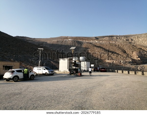 Ras Al Khaimah, United Arab Emirates - August 18,\
2021: Free public viewing point at Jebel Jais desert mountain\
range, the highest land point in the UAE at elevation of 1,934\
meters above sea level.