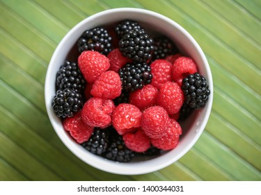 Raspberries And Blackberries In A Bowl